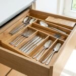 Drawer-divider-_-A-beautifully-organized-modern-under-counter-drawer-with-a-stunning-bamboo-expandable-organizer-holding-matching-silverware.-Bright-natural-lighting